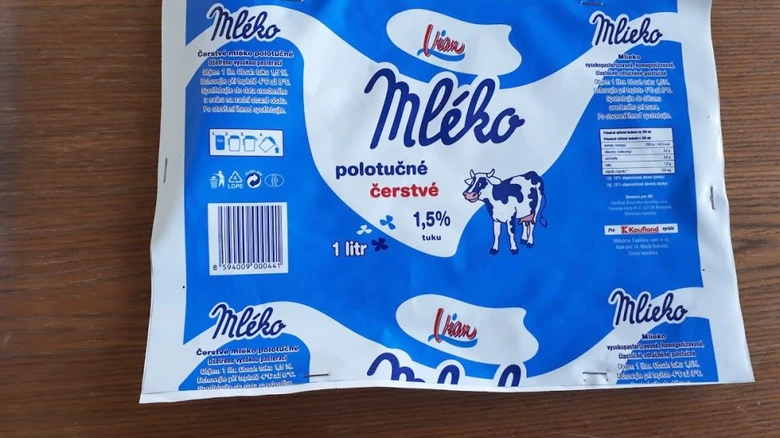 Modrý sáček mléka značky Lian na dřevěném povrchu.